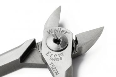 The image shows a pair of metal pliers with a sharp tip and a shiny finish. The pliers have a precise, compact shape and bear a brand name.