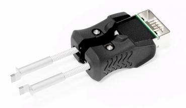 The image shows an adapter with two silver pins and a black, ergonomically shaped handle. The upper part has a connection that resembles a USB port.