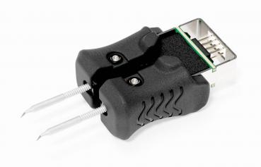 The image shows a black adapter with a USB plug at one end and two pins at the other end. The adapter has a rubberized, textured surface for better grip.