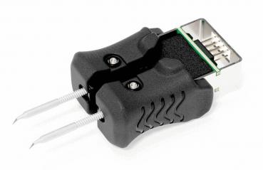 The image shows a black USB adapter with two metallic pins. The adapter has a tiered shape and a standard USB port visible on the top.