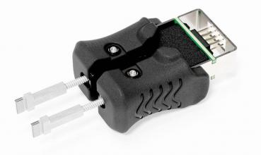 The image shows a black device with two side levers and a connection socket. It has an ergonomic shape and displays technical details for connecting or adjusting cables.