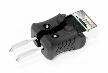Das Bild zeigt ein schwarzes Gerät mit zwei grifffreundlichen Seiten, die wie Gummi aussehen. An einem Ende ist ein Verbindungselement sichtbar, das für elektrotechnische Anwendungen genutzt wird.