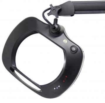 The image shows a black magnifying glass with integrated light, attached to a flexible arm. It has an oval opening and controls on the side.
