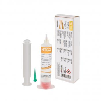 The image shows a tube with orange and white lettering containing a yellowish liquid. Next to it is a gray syringe and a small green tip. In the background, there is a white package with information and warning labels.