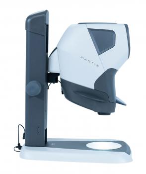 The image shows a compact, usually light gray device with rounded shapes. It features a camera view, a stable base, and controls on the side. Ideal for enlarging texts.