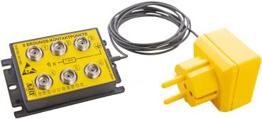 The image shows a yellow junction box with six round sockets and a cable. Next to it is a yellow power plug with two flat prongs.
