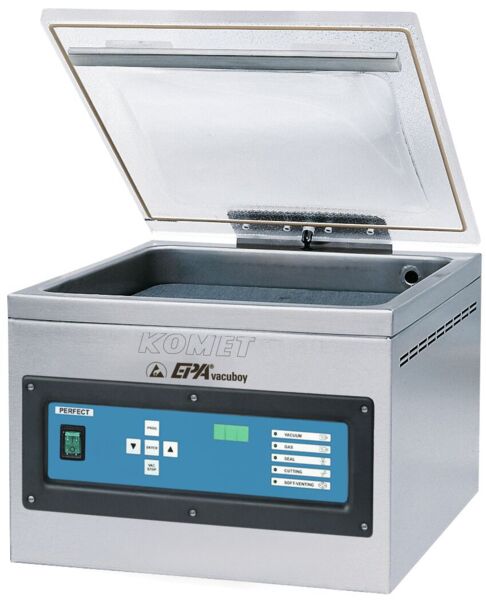 The image shows a kitchen appliance, a vacuum sealer. It has a rectangular, metallic casing with a transparent lid. On the front, there are controls and a digital display.