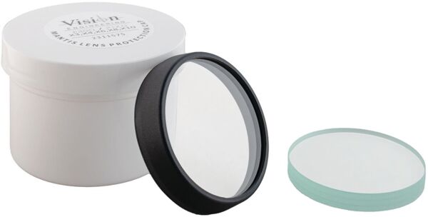 The image shows a round, clear lens with a black rim, standing on a white container. Next to the container is another round lid in light blue.