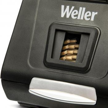 The image shows a black pen with the ?Weller? logo. At the top, there is an opening from which small metal tips are visible, and below that, a silver button.