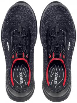 Here are two black athletic shoes with a smooth upper. They have a round toe cap, a comfortable shaft, and black laces with red accents.