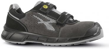 The shoe is a sporty, dark sneaker with gray and black elements. It has a padded collar, a non-slip sole, and two Velcro straps for a secure fit.