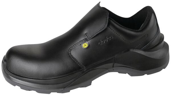 The image shows a black safety shoe without laces. It has a smooth leather surface, an ergonomic shape, and a slip-resistant, thick rubber sole.
