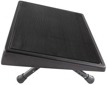 The image shows a slanted footrest with a non-slip surface. It has adjustable legs that allow for individual height adjustment. The color is black and the texture is grooved.