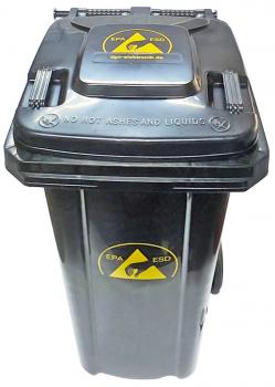 The waste container is black with a yellow hazard symbol indicating radioactive materials. It has a solid lid and wheels for transportation.