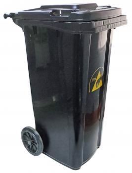 The garbage container is black, has two wheels for movement, and a removable lid. On the front, there is a warning sign with a yellow triangle.