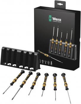 The image displays a set of seven small screwdrivers with yellow and black handles. They are arranged in a compact, black stand that also serves as packaging.
