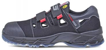 The image shows a black safety shoe with Velcro fastenings. It has a sturdy design, side ventilation slots, and a conspicuous, non-slip sole.