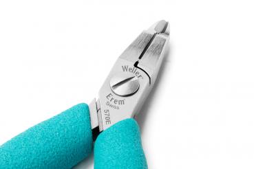The image shows a pair of pliers with grippy, turquoise handles. The tip of the pliers is made of shiny metal and has a flat, sharp edge. It appears precise and handy.