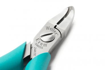 The image shows a shiny pair of pliers with narrow, pointed jaws and an elegant design. The handles are in a bold turquoise, and the surface is metallic and smooth.