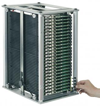 The image shows a rectangular metal device bay with several vertically arranged green circuit boards. A hand reaches for the left side of the device.