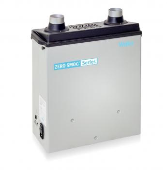 The image shows a rectangular, silver-colored device with two round outlet openings on top. It has a black top with the inscription 