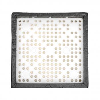 The image displays a square area with a black border. In the center, there are many small, uniform holes arranged in various patterns. It appears structured and symmetrical.