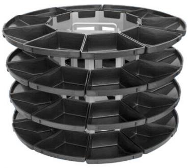The image shows a stackable container with multiple, flat compartments. It has a round shape and is made of black material, ideal for storing or organizing items.