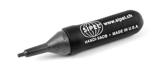 In the picture, there is a black marker against a neutral background. The marker has a pointed, felt-like tip and is labeled with a logo and the note "HANDI-VAC® MADE IN U.S.A."
