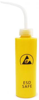 The image shows a yellow bottle with a long, upward curved spout. On the front, there is a black symbol featuring a hand gesture and the text "ESD SAFE".