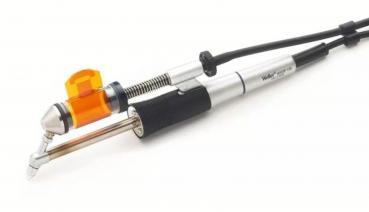 The image shows a tattoo device with a silver and black casing. It has an orange attachment and a long cable connection. The shape is slim and ergonomic.