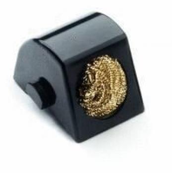The image shows a small, black, wedge-shaped object with a round, golden surface texture. It has a smooth side and a lateral adjustment screw.
