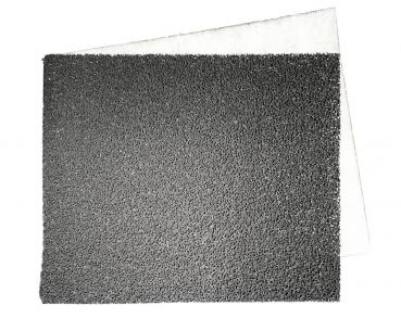 The image shows a piece of sandpaper lying on a light surface. The top is rough and dark gray, while the back is smooth and light.