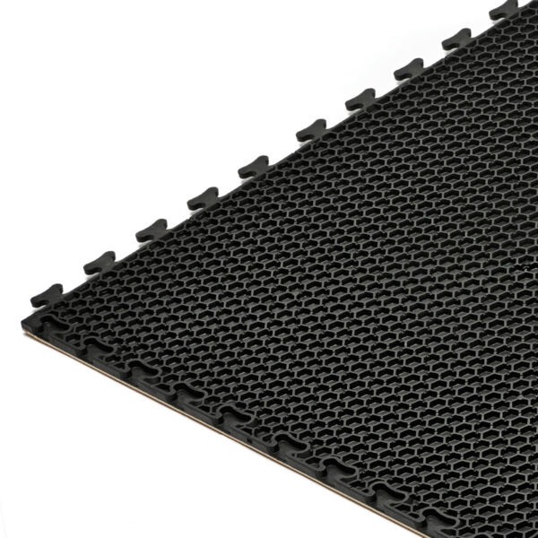 The image shows a rectangular, black rubber mat with a textured, honeycomb-like pattern. The edges have connectors to join multiple mats together.