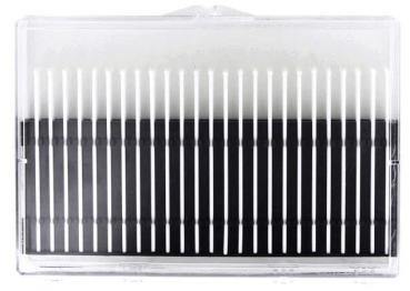 The image shows a transparent box filled with many thin, parallel black and white strands. The strands are evenly arranged and form a pattern.