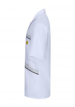 The image shows a white, short-sleeved shirt. It features a simple collar and a chest pocket with a decorative line underneath. A yellow label is visible on the side.