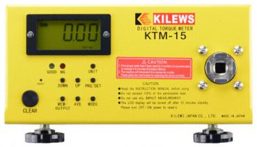 The image shows a digital torque meter. It has a yellow casing with a large digital display and various buttons. On the right side, there is a round socket.