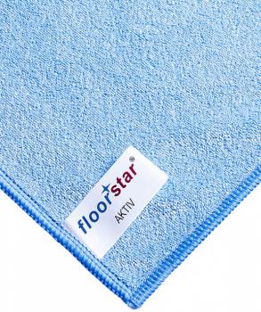 The image shows a light blue cloth, smooth and wrinkly. It is folded and has a labeled corner. The texture appears soft and light.