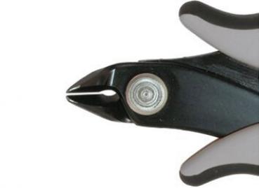 The image shows the tip of a side-cutting pliers. The handles are non-slip with a black and gray surface. The pliers have a round head with a sharp cutting edge.