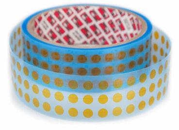 The image shows two rolls of adhesive tape. The top tape is transparent with golden dots, while the bottom one has a blue border. The inner core is red with a cross pattern.