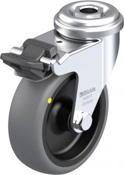 The image shows a gray, round wheel with a metallic axle. It has a braking mechanism and is solidly constructed. The manufacturer is 