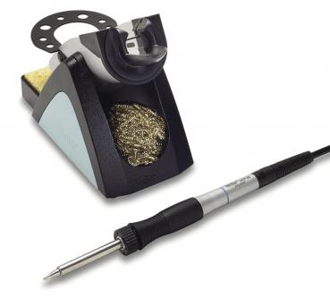 The image shows a soldering iron with a cable and a soldering iron stand. The stand is black with gray and metallic elements and includes a fine, metallic cleaning spiral.