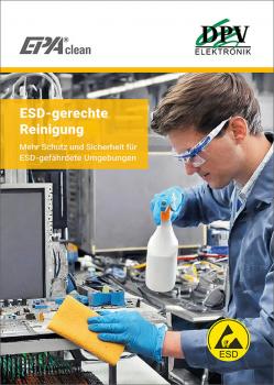 In the picture, there is a worker in protective clothing working at a table with electronics. He is holding a spray bottle and a sponge to safely clean areas at risk of ESD.