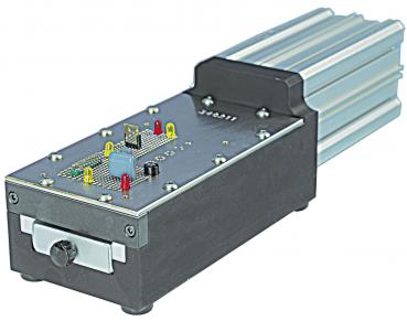 The image shows a technical device with a rectangular casing. On the top side, there are small colorful LEDs and electronic components visible. On one side, there is a rotary knob attached.