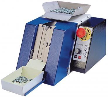 The image shows a machine with a blue casing. A movable arm with a black button and a chain leads to a large wheel. To the right, there is a red emergency stop button.