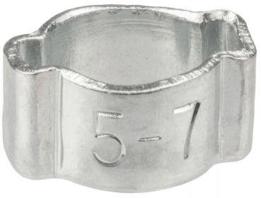 The image shows a small, silver metal bracket. It has a round opening in the center and is slightly wavy at the top and bottom. On the side, the numbers "5-7" are engraved.