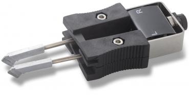 The image displays a technical connector with two metallic contacts. It features a black plastic handle and a control lever marked with the letters 