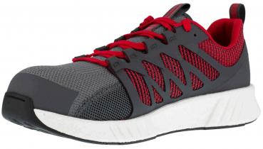 Der Schuh ist sportlich mit einer grauen Mesh-Oberfläche und roten Akzenten. Er hat eine breite, weiße Sohle und rote Schnürsenkel, die gut sichtbar sind.