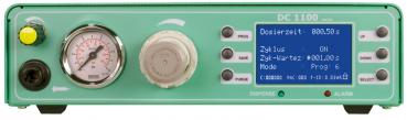 The image shows a green device with a digital display, a pressure gauge, several buttons, and a rotary control. It is likely used for dosing or controlling a process.