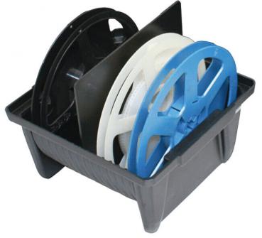 The image shows a gray box with three rollers. One roller is black, one is white, and one is blue. The rollers vary in size and are arranged with the blue one on top.