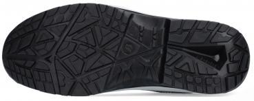 The image shows the sole of a sports shoe. It is flat and has a deep tread with various geometric patterns that provide good traction and grip. The color is black.